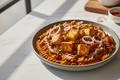 Sprouted moth beans fusilli in an onion tomato masala with paneer