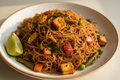 Deep red sprouted Navara red rice vermicelli plated with a tempering