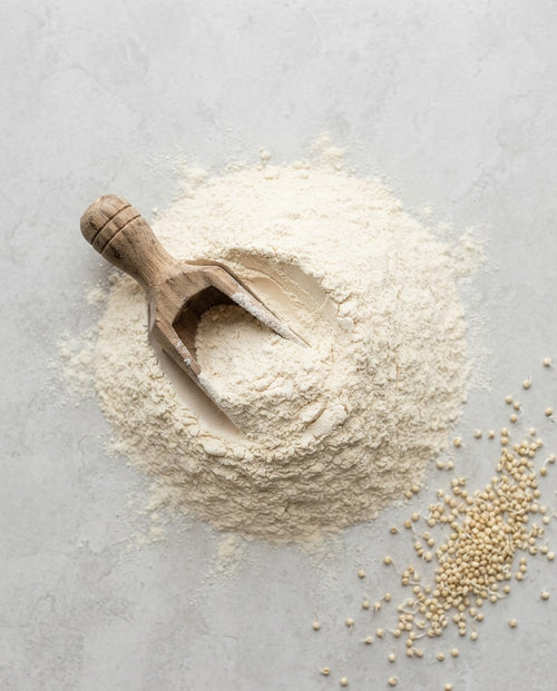 Stone-ground sprouted little millet flour with a wooden scoop